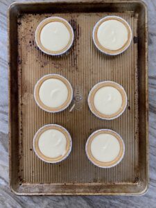 A picture of mini cheesecakes about to go in the oven