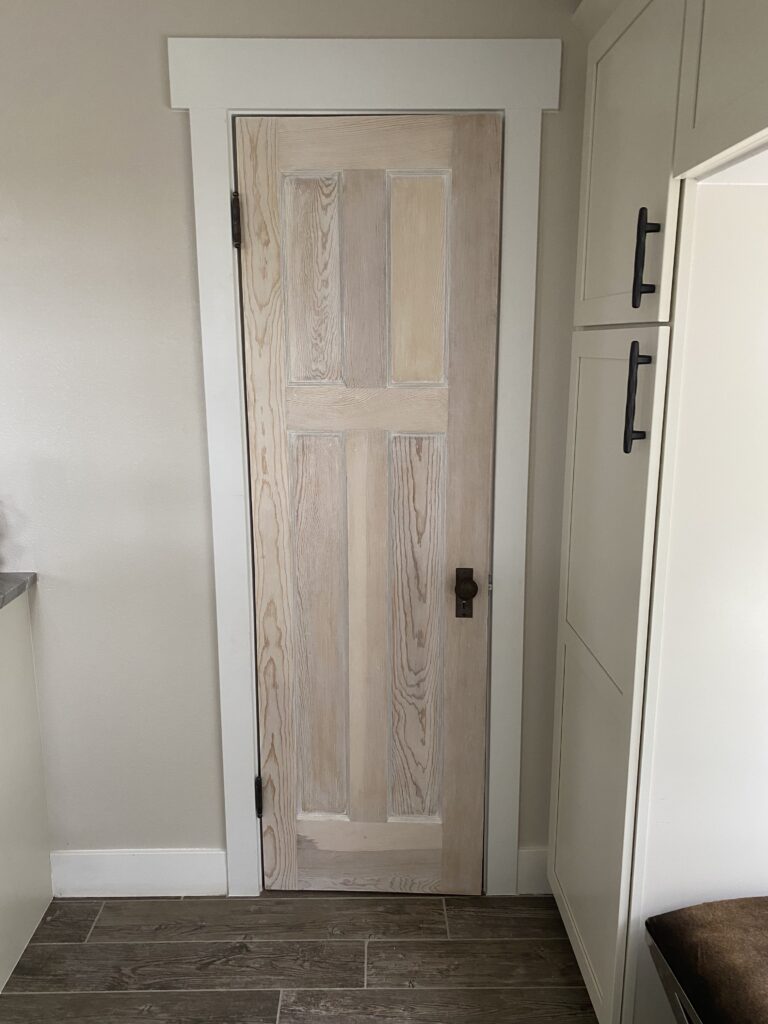 A picture of a refinished salvaged antique door in a modern farmhouse 