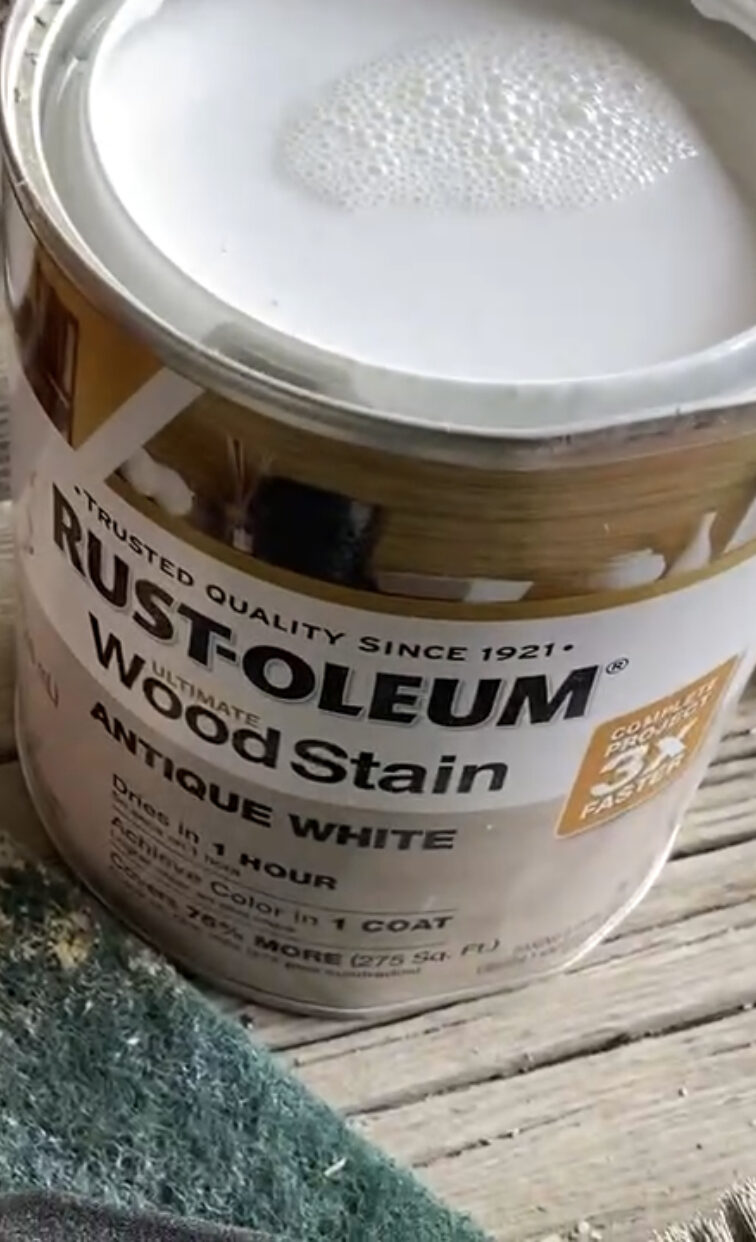 A picture of and open can of antique white wood stain 